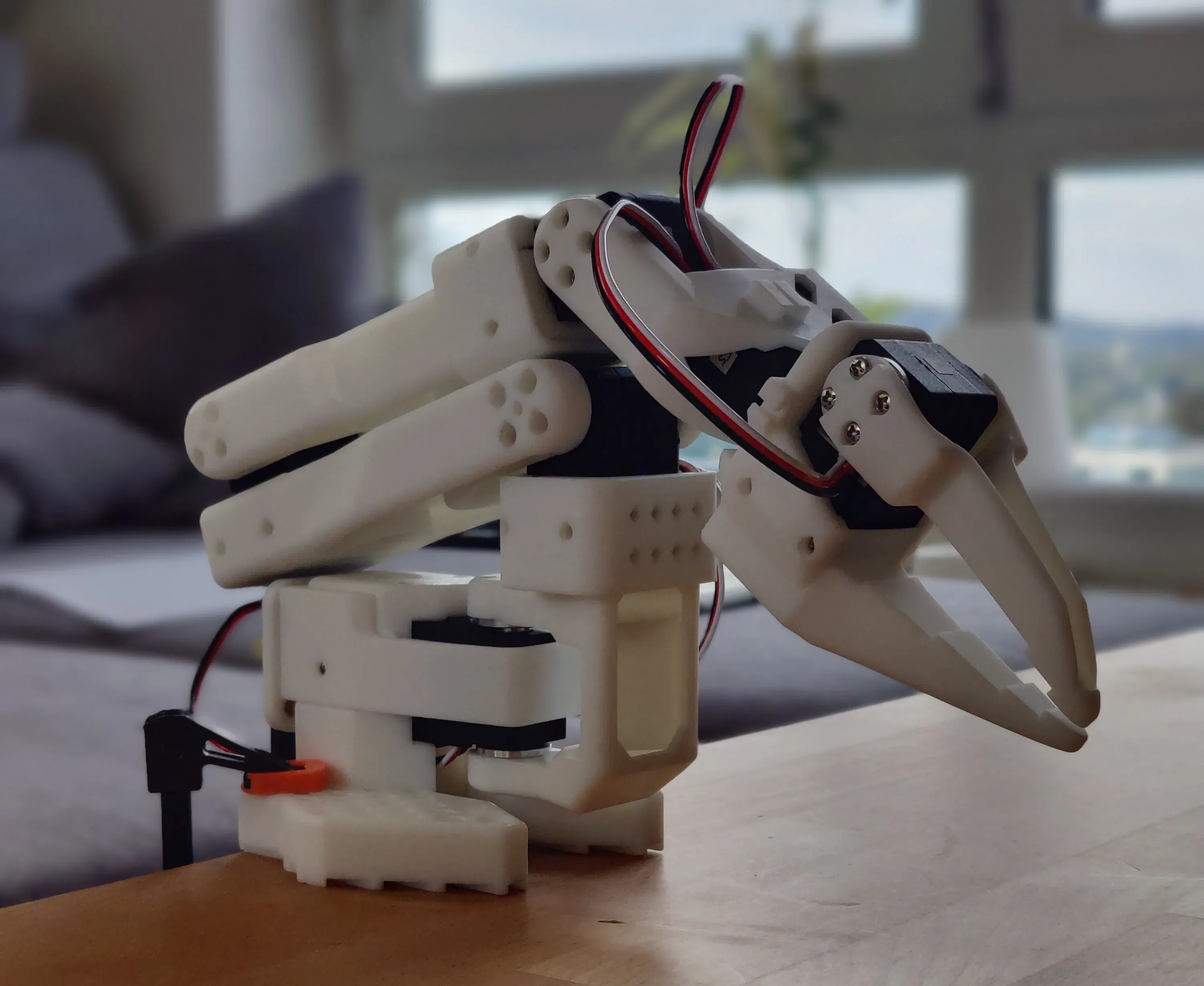 The assembled follower arm, a printed six-joint arm with a two-finger gripper